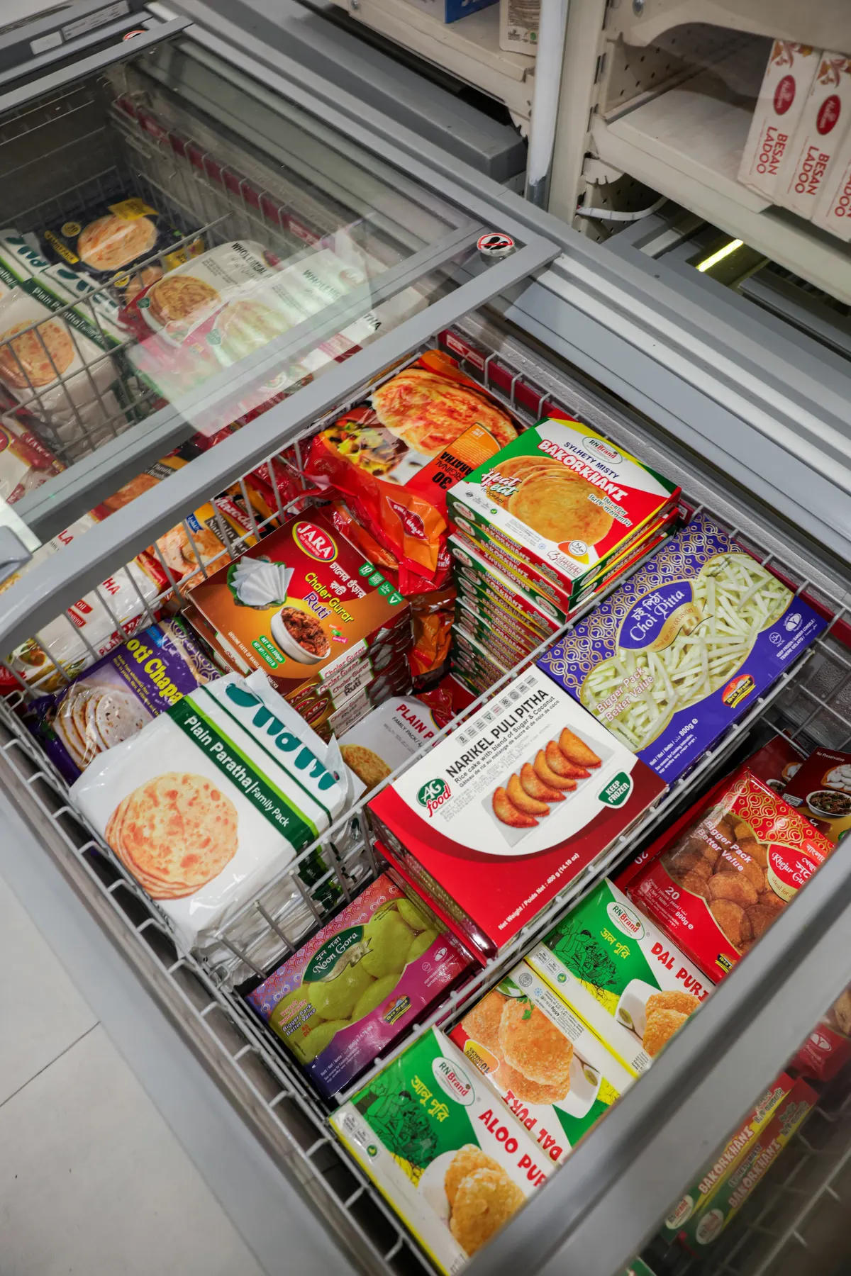 A freezer of parathas, samosas and frozen snacks