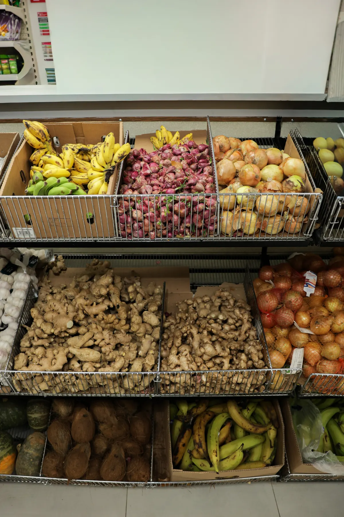 Baskets of plantain, ginger, yam, red onions and bananas