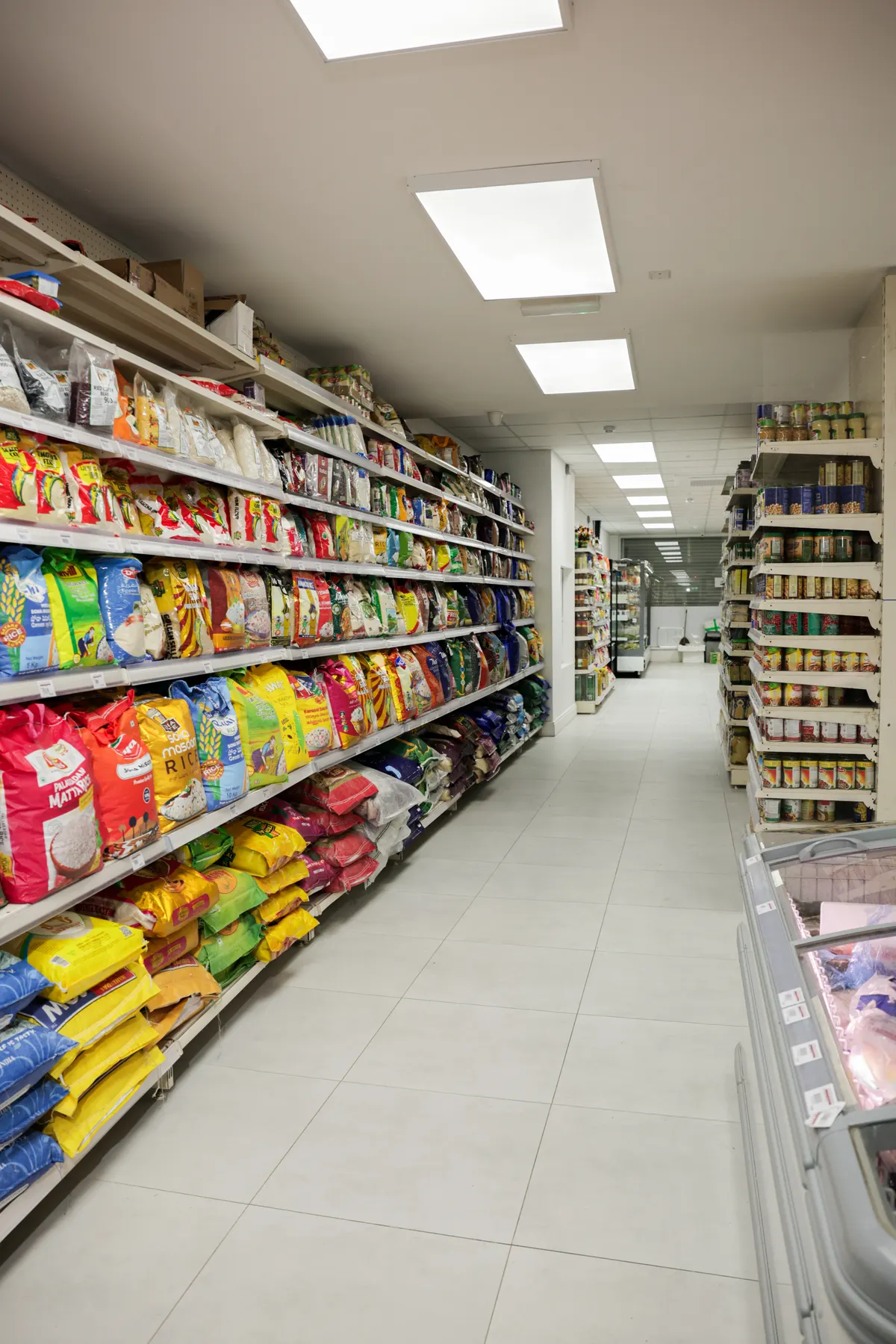 The rice and flour aisle, stacked with big bags of basmati and atta