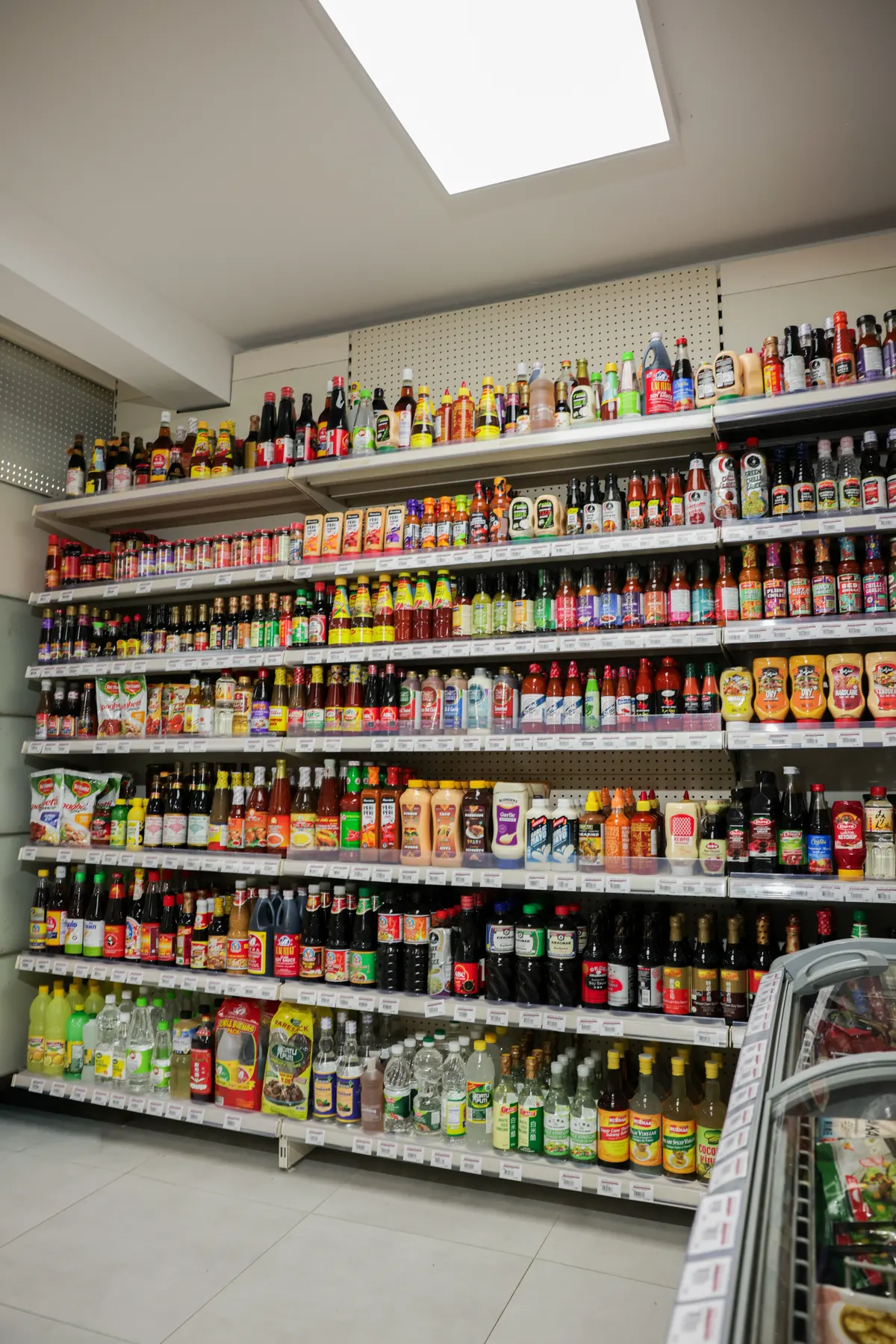 A wall of sauces, oils and bottles from many countries