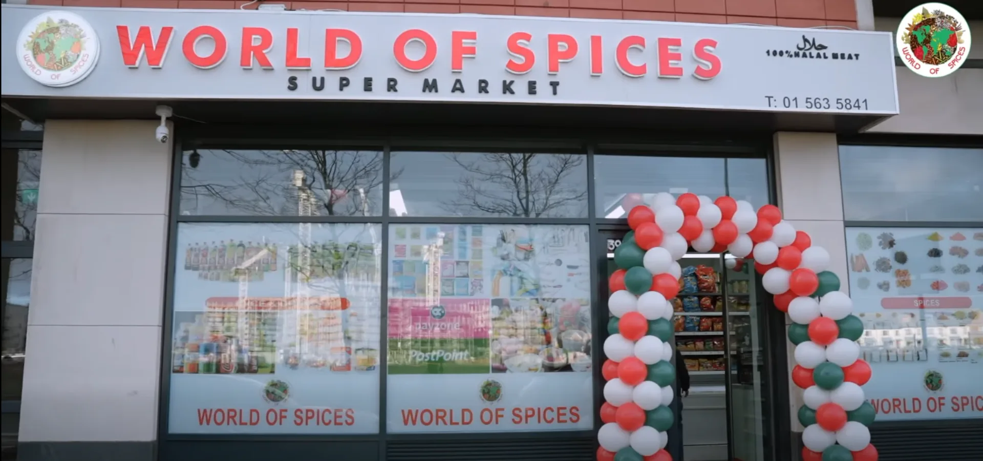 World of Spices supermarket shopfront on opening day, with a red, white and green balloon arch over the door